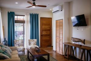 a living room with a couch and a ceiling fan at Ocean & Lighthouse view apartment in Playa Venao