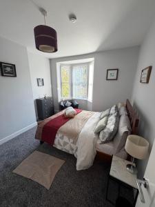 a bedroom with a bed and a window at Graham Road in Rugby +6 photos