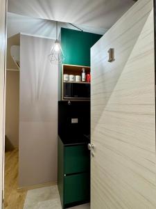 a door leading into a room with a green cabinet at Duomo Next Accomodations in Trento