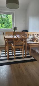 a wooden dining table and bench in a room at Blick-ueber-Hohegeiss in Hohegeiß