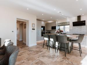 a kitchen and dining room with a table and chairs at Copper Beech Cottage in Welshpool