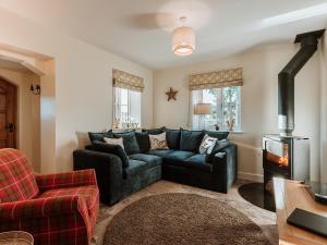 a living room with a couch and a fireplace at Copper Beech Cottage in Welshpool +28 photos