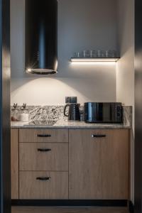 a kitchen with a counter top with a microwave at Residence Tatrzański Park in Poronin +15 photos