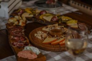a table topped with plates of food and glasses of wine at Etno Garden Apartments in Plitvička Jezera