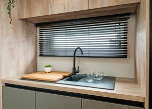 a kitchen with a sink and a window at Monarch Lakes in Boston