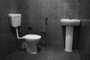 a bathroom with a toilet and a sink at The Guwahati Penthouse in Guwahati +45 photos