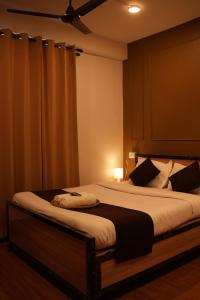 a bedroom with a large bed with a ceiling at The Guwahati Penthouse in Guwahati