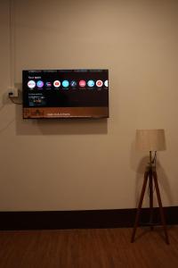 a flat screen tv hanging on a wall at The Guwahati Penthouse in Guwahati