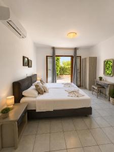 a large bedroom with a large bed and a desk at Aristomenis Studios in Vlachata +97 photos