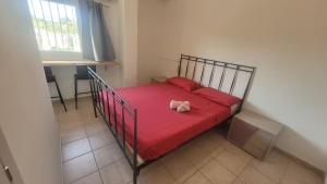 a bedroom with a bed with red sheets and a red blanket at B&B Aut in Fiore in Ravenna