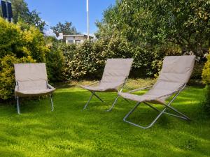 two chairs sitting in the grass in a yard at Smart Suite at Villa Anna - Bike Friendly in Buonconvento