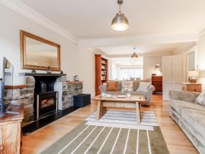 a living room with a couch and a fireplace at Mill View in Aberfeldy