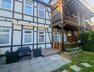 a house with a deck and a balcony at Einzelwohnung im EG mit Terrasse und AC in Osterburg Siedlung