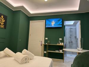 a green bedroom with a bed and a shower at Duomo Next Accomodations in Trento +16 photos