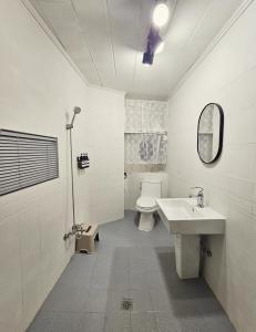 a white bathroom with a toilet and a sink at Busan Harbor Stay in Busan +42 photos