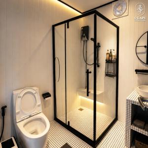 a bathroom with a toilet and a glass shower at S-Cape at Rim Khwae in Ban Tha Thong Mon +36 photos