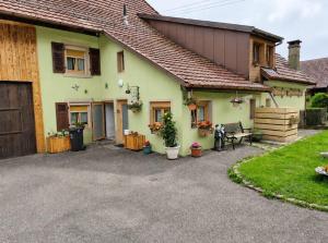 a house with a gravel driveway in front of it at Gite la Tourbiere in Fellering