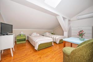 a room with two beds and a tv and a couch at Bajka in Dąbki +59 photos