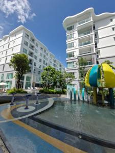 a water park in front of two buildings at Serenity Naiyang Най Янг D02 in Nai Yang Beach