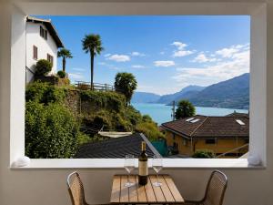 a window with a bottle of wine on a table at B&B Belvedere in Colico