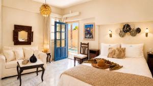 a bedroom with a large bed and a couch at Villa Kallergi Athena in Loutra +75 photos
