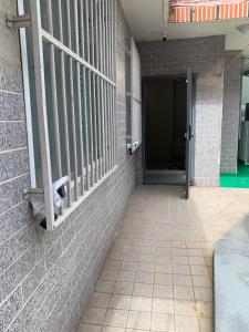 a door to a building with a brick wall at Busan Harbor Stay in Busan