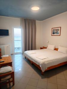 a bedroom with a bed and a view of the ocean at Ocean Dreams in Palaiochora