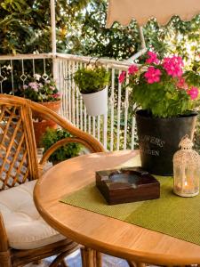 a wooden table with a candle and flowers on it at Alexandra's house in Arta