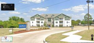a rendering of a large apartment building with a driveway at StarkVilla - The Perfect Location! in Starkville