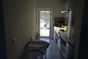 a kitchen with a stool in the middle of a room at Ocean Dreams in Palaiochora