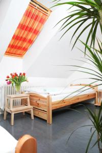 a bedroom with a wooden bed and a table at Pension am Rathaus in Hamburg