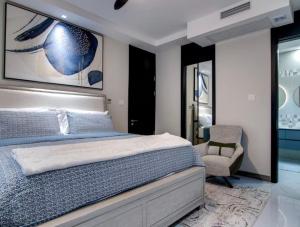 a bedroom with a bed and a chair at The St Ann Haven in Seville