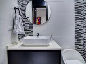 a bathroom with a white sink and a mirror at The St Ann Haven in Seville +10 photos
