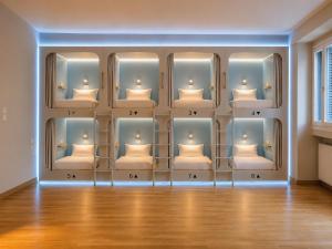 a room with a wall of shelves with beds at BeachBox in Piraeus