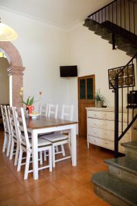 a dining room with a table and white chairs at Cas Coco – 8-Person Townhouse near Playa de Muro ⭐ in Muro