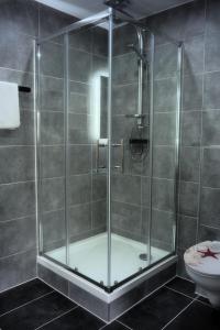 a shower with a glass door in a bathroom at Hotel Gasthaus Krone in Cologne +20 photos