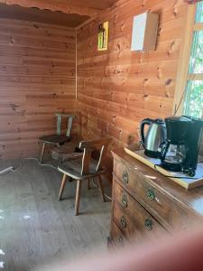 a room with a wooden wall with a counter and a stove at la roulotte chez Camille in Veynes
