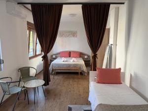 a bedroom with a bed and a table and chairs at Appartement UNA La Bella 3* in Bihać