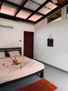 a woman laying on a bed in a bedroom at Glass Roof Southern Edge Cabanas in Tangalle +24 photos