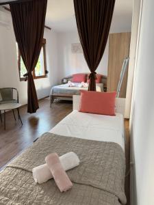 a bedroom with a bed with two towels on it at Appartement UNA La Bella 3* in Bihać