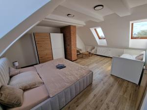 a large bedroom with a bed and a staircase at Zelená in Františkovy Lázně