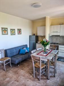 a kitchen and living room with a table and a couch at La Casa del Cedro - Riposto in Riposto