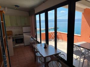 a kitchen with a table and a view of the ocean at Villa Miranda - Croazia in Omiš