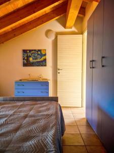 a bedroom with a bed and a closet and a door at La Casa del Cedro - Riposto in Riposto