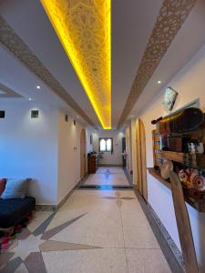 a hallway with a yellow ceiling and a living room at Ifni Flow Seafront surfhouse in Sidi Ifni