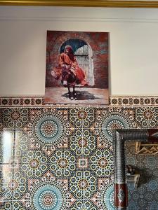 a painting of a woman on a tile wall at Ifni Flow Seafront surfhouse in Sidi Ifni +58 photos