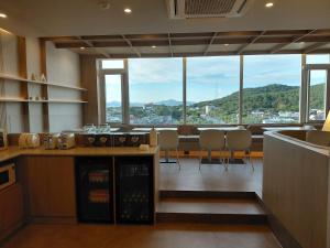 a kitchen with a counter and a view of a city at Mare Suite Hotel in Incheon