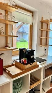 a kitchen with a table with a toaster on it at Ferienhaus am Land in Mogersdorf +19 photos