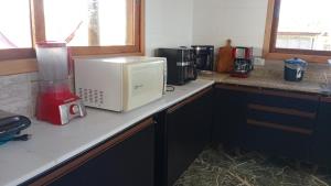 a kitchen counter with a blender and appliances on it at Chacara Mansao completa 28 pessoas TOMORROWLAND in Itu