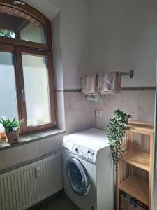 a laundry room with a washing machine and a window at Ferienwohnung Am Bürgerteich in Bischofswerda
